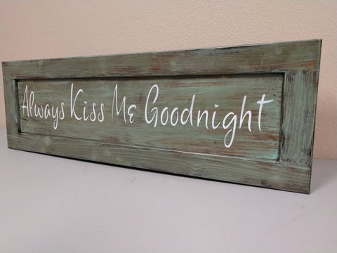 Olive green, distressed wooden wall art with quote "Always Kiss Me Goodnight".
