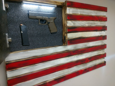 An American gun concealment flag with motion activiated LED lights, with its hidden compartment open to reveal a handgun. 