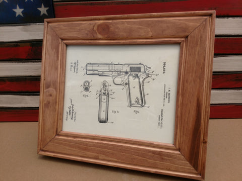 An 8x10 cherry wood gun concealment picture frame with a diagram of a Browning handgun inside. 