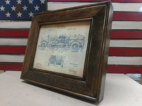An 8x10 dark walnut gun concealment picture frame with a diagram of an old, vintage car from 1912 inside. 