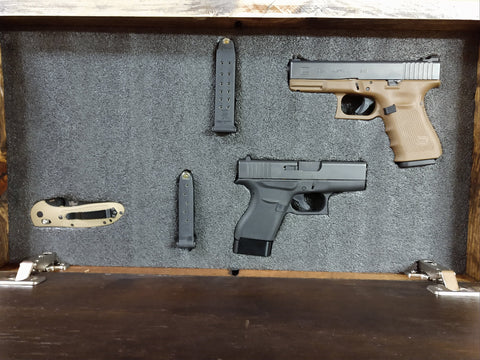 Mini, dark brown gun concealment box open to show 2 handguns, 2 ammunition pouches, and 1 knife.
