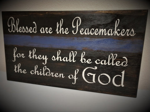 Hanging gun concealment art with quote "Blessed are the peacemakers for they shall be called the children of God".