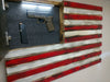 An American gun concealment flag with motion activiated LED lights, with its hidden compartment open to reveal a handgun. 