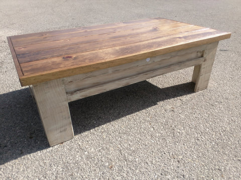 A distressed white wooden gun concealment coffee table with a sliding top.