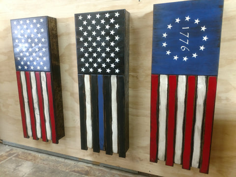 3 vertically hanging half sized American flag gun concealment cases, 1 classic U.S flag, 1 black & white with blue stripe, & 1 colonial style