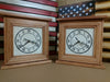 Two cherry wood concealment clocks with white faces, sitting in front of two American gun concealment flags.
