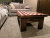 A gun concealment coffee table with an American flag sliding top sitting in a living room.