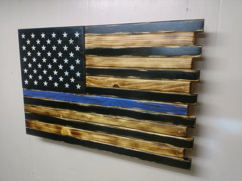 Torched Thin Blue Line concealment flag uses black and torched wood to create the US flag with white stars and a central blue stripe