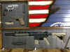 A gun concealment flag with 2 panels open to small and large units, foam lining holding gear, partial hybrid navy design visible on fixed panel