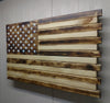 Charred American flag gun concealment case with light & dark brown wood stripes and a dark brown wood upper left with white stars.