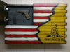 Upper left open panel of a wooden concealment flag with pistol and magazine, design transitions to a yellow with a black "Don't Tread on Me" snake logo.