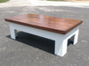 A white gun concealment coffee table with an unpainted sliding top.