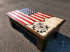 A gun concealment coffee table with an American flag sliding top with a US Coast Guard logo painted on it.