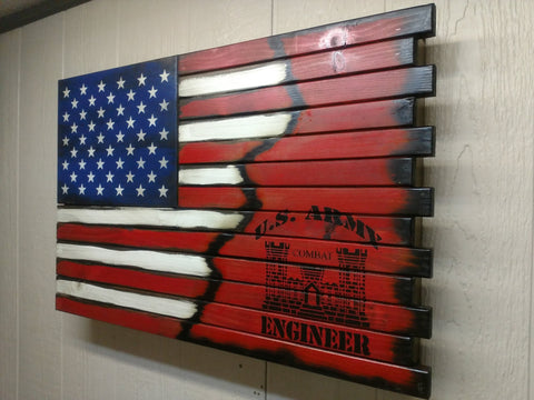 A large gun concealment case with a US flag transitions into a red background with a large black US Army Corps of Engineers logo