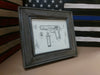 An 8x10 distressed grey gun concealment picture frame with a diagram of a Browning handgun inside. 