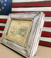 An 8x10 distressed white gun concealment picture frame with a diagram of a John Deer tractor inside.
