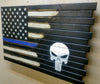 The Thin Blue Line concealment flag converts left to right into a big white stencil design of the Punisher skull over a black background