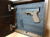 Interior of mini, hidden gun storage box with 1 handgun and ammunition in foam insert.