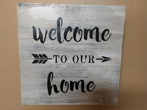 "Welcome to our home" hidden gun storage sign hanging on wall.