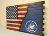 A large US gun concealment flag transitions diagonally into a blue background with a large white stencil of the Navy Seabees logo