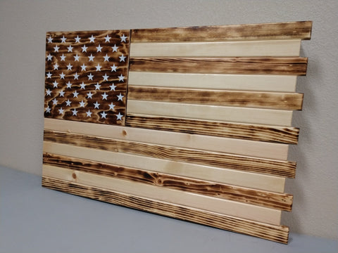 Charred design US concealment flag made from light natural wood that has dark accents from what appears to be burning