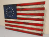 1776 design concealment flag with the upper left blue area having the year 1776 in the middle of 13 stars in a circle, red and white stripes