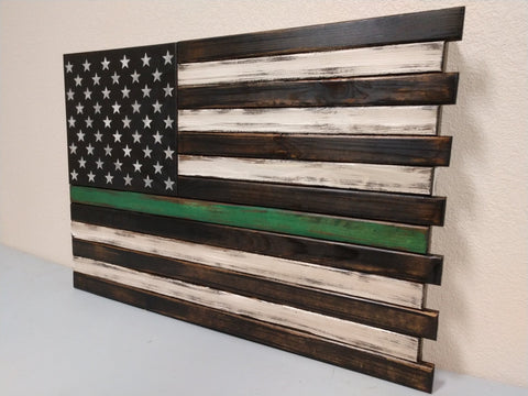 Thin Green Line hidden gun safe that features a single green stripe that is positioned centrally amidst a monochromatic style US flag