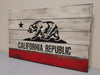 Concealment flag with the California bear and star that below reads California Republic over distressed white paint with red bottom plank