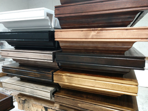 A stack of wooden gun concealment shelves in a variety of different colors. 