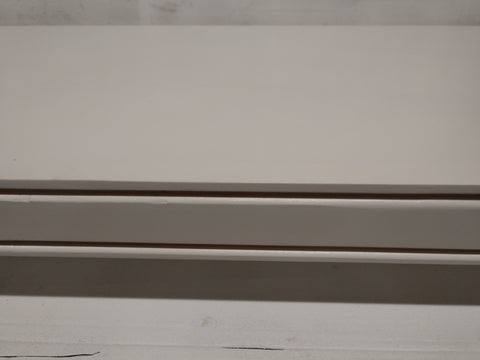 A wooden gun concealment shelf painted white. 