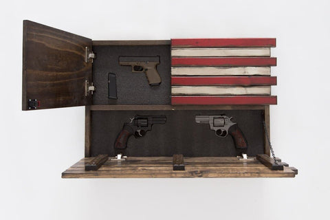 A gun concealment case with two compartments open holding a pistol and ammo clip in the top left and two revolvers in the bottom