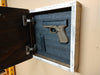 Handgun and ammunition nestled in the foam interior of the hidden gun storage box.