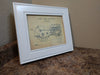 An 8x10 gun concealment picture frame finished in white with a diagram of a John Deer tractor inside. 