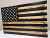 Single compartment American flag gun concealment case with black & natural wood stripes & a black upper left with white stars.