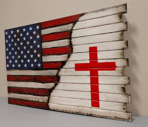 A large American gun concealment flag diagonally transitions into to a large red cross stenciled lower right on top of a white background